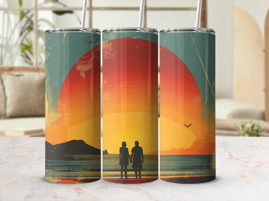 Couple holding hands on a beach at sunset, on a metal tumbler.