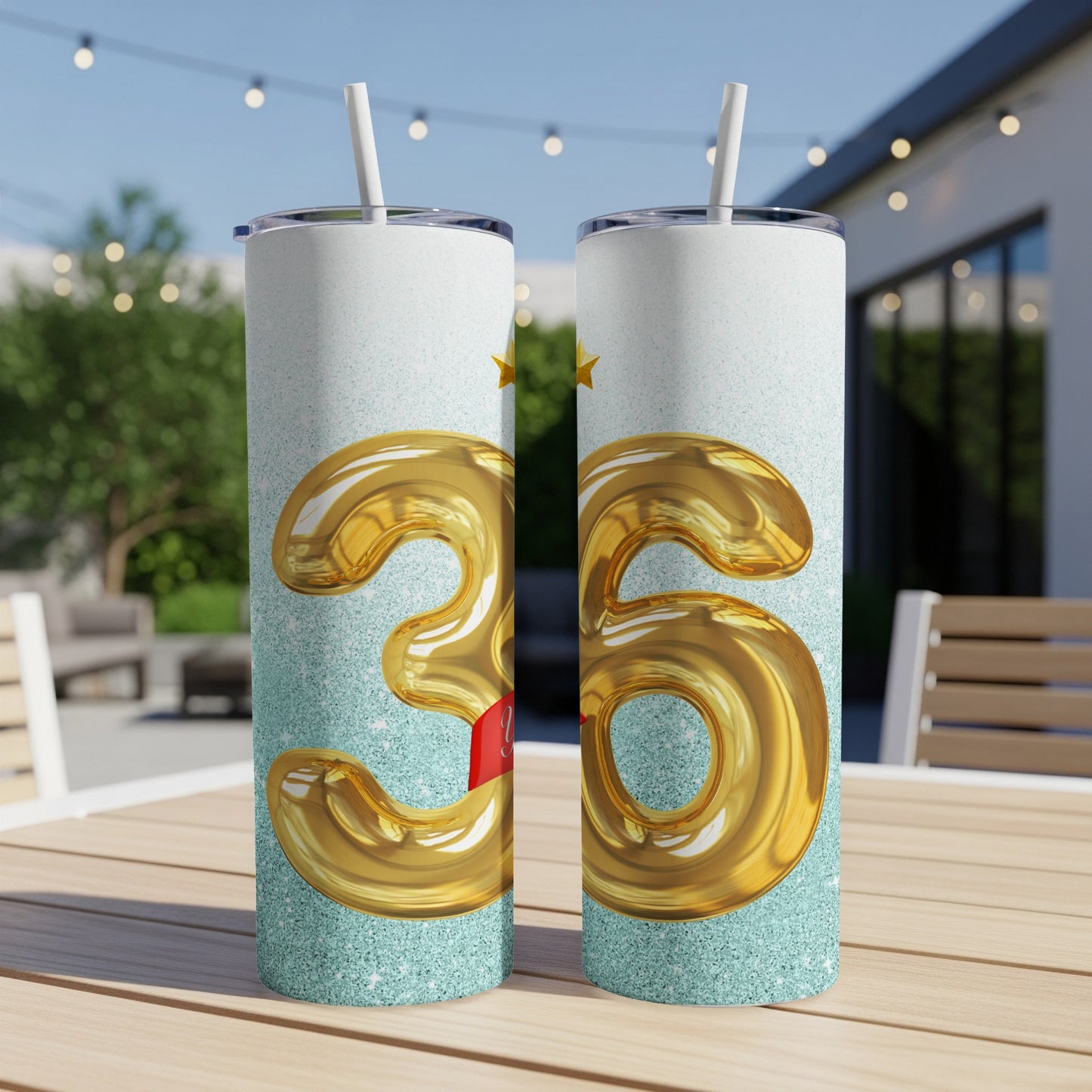 Two 35th birthday tumblers with gold balloons and stars.