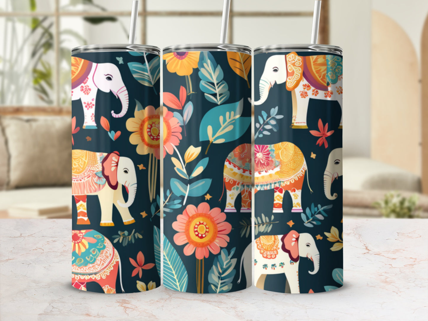 Three tumblers with colorful elephant and floral patterns on a marbled surface.