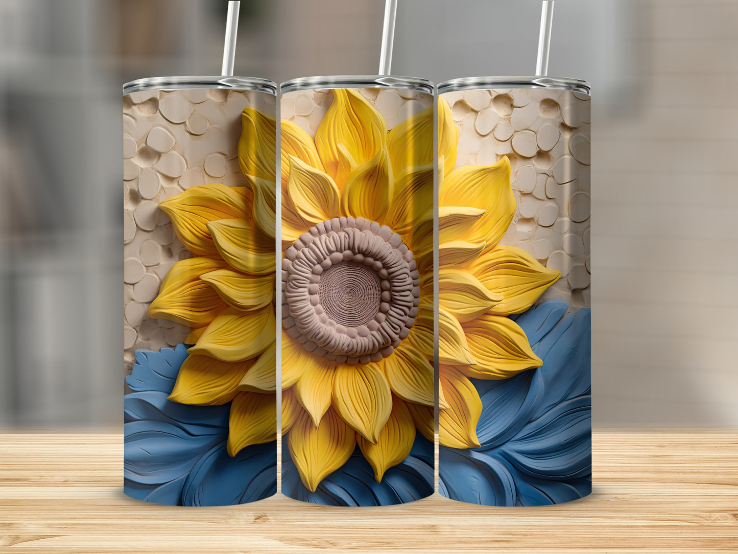 Three sunflowers with blue leaves on a textured background, on tumblers.