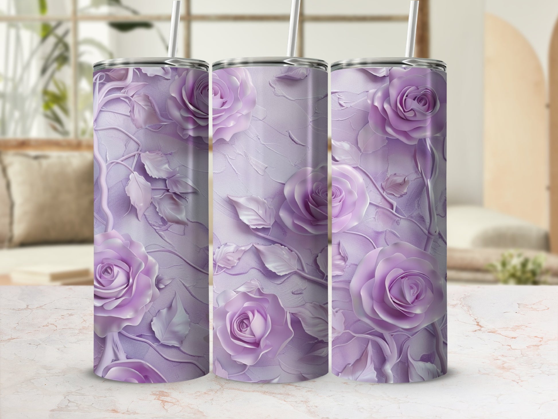 Three purple floral pattern tumblers with straws on a marbled surface.