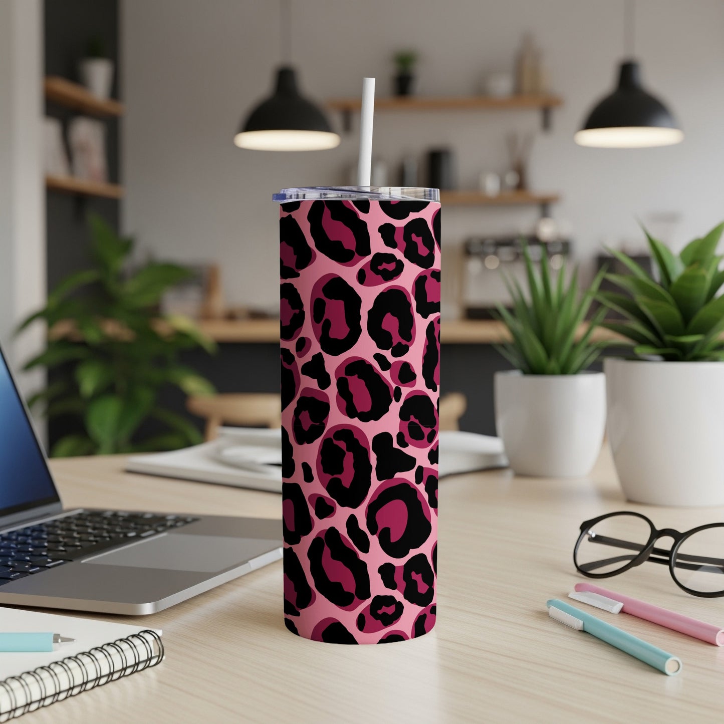 Pink tumbler with a dark pink and black leopard print pattern.
