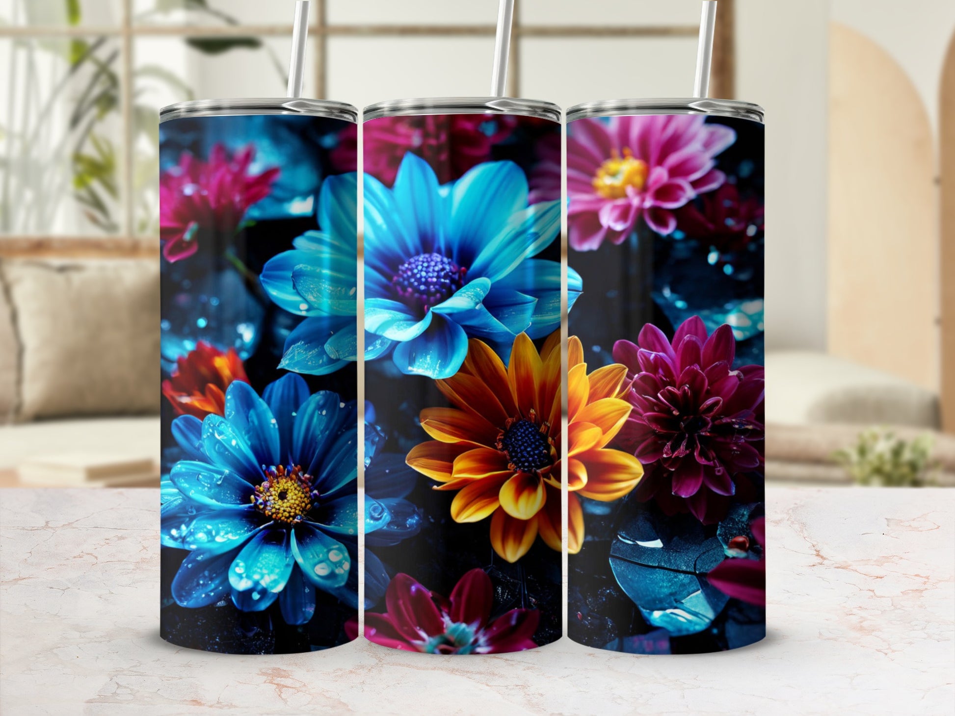Three colorful tumblers adorned with vibrant floral designs.