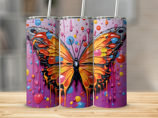Three tumblers with a colorful butterfly and paint splatter design.