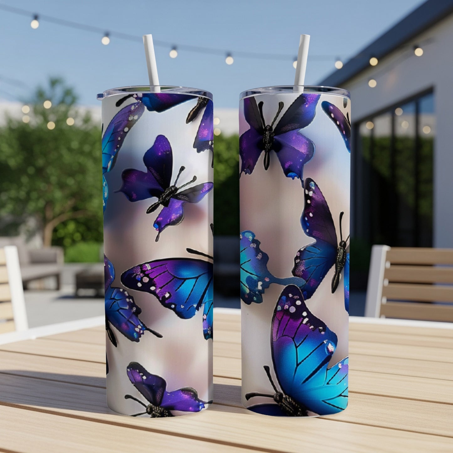 Two tumblers with iridescent purple and blue butterflies on a wooden table.