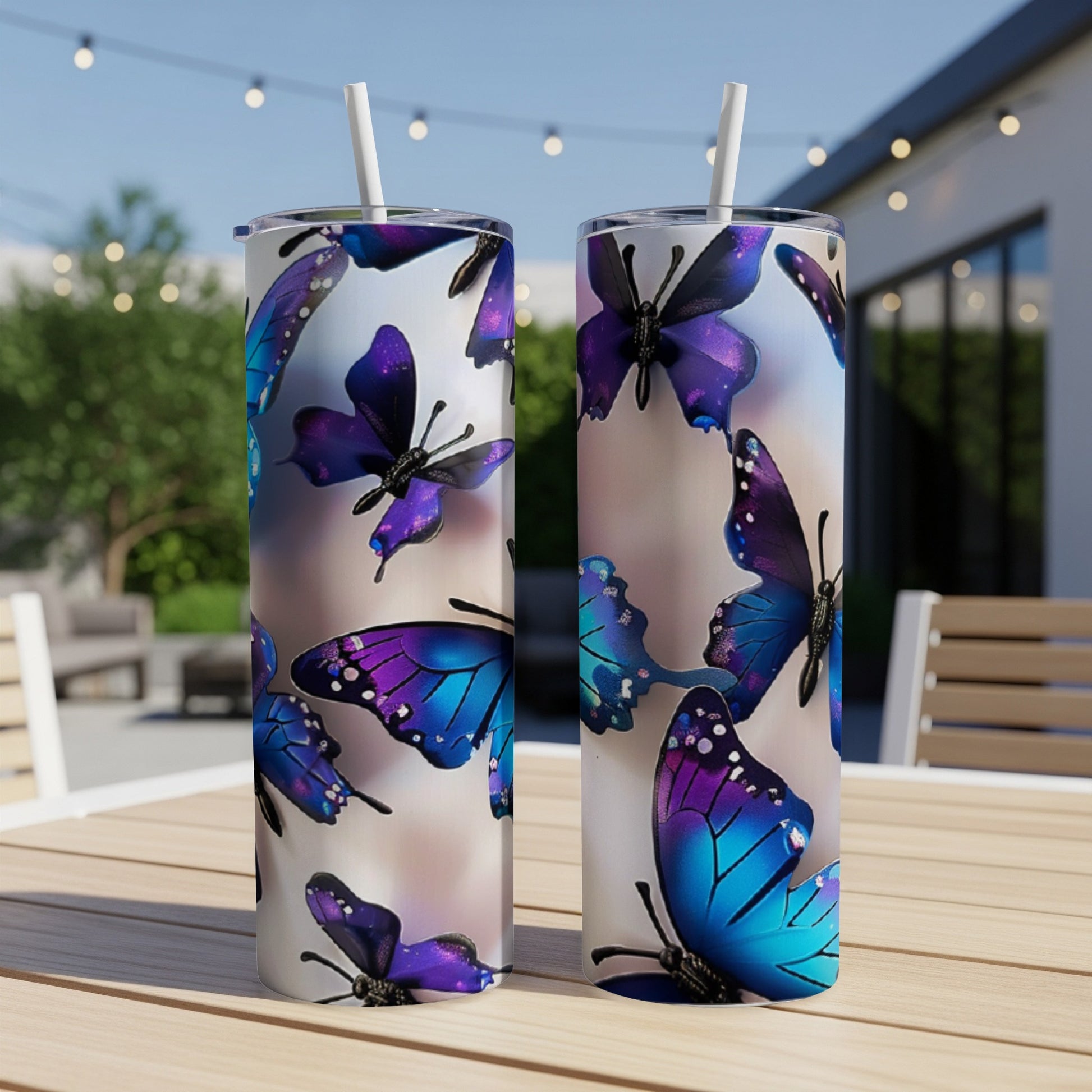 Two tumblers with iridescent purple and blue butterflies on a wooden table.
