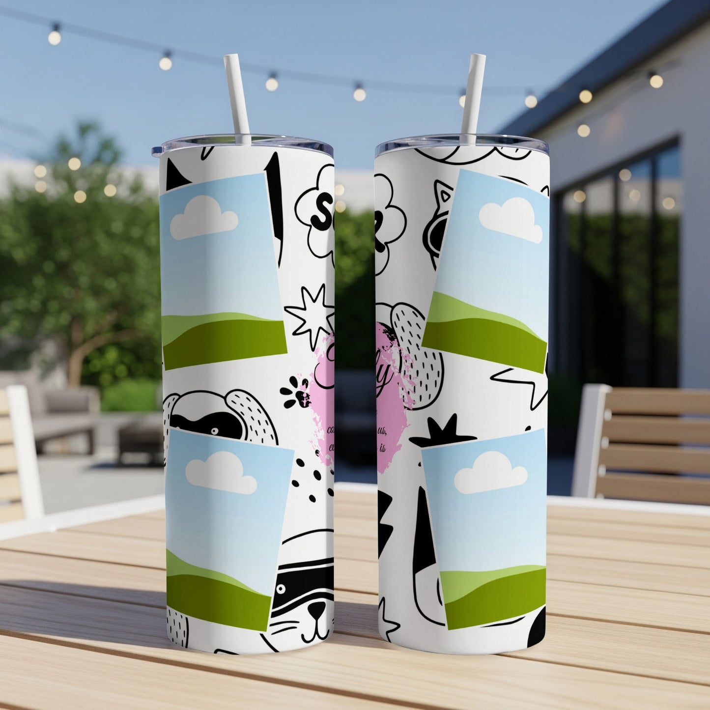 Two white tumblers with playful cartoon designs, clouds, and landscape scenes.