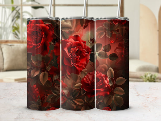 Three tumblers adorned with deep red roses and dark leaves, set against a blurred background.