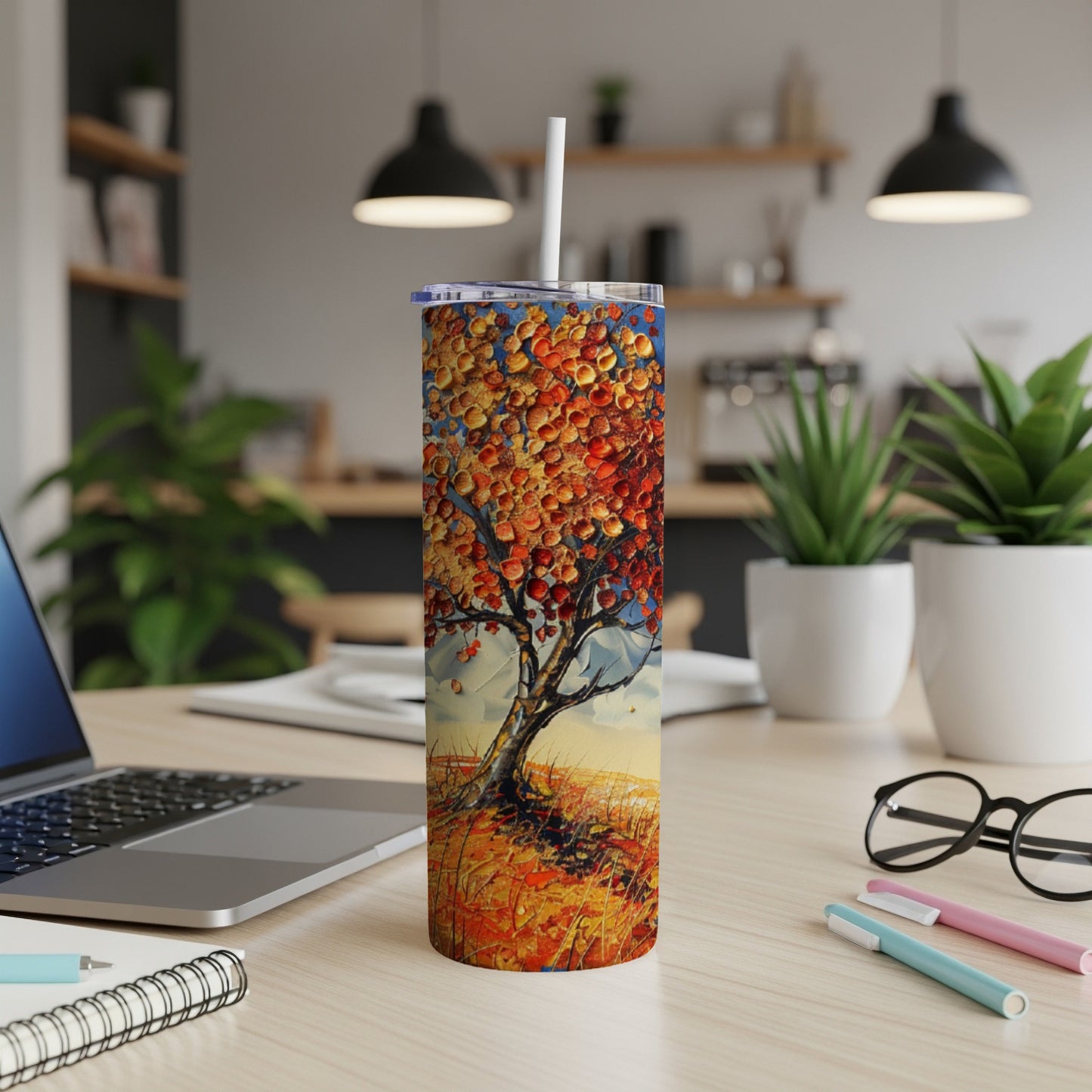 Tall tumbler featuring a vibrant autumn tree scene with straw lid.