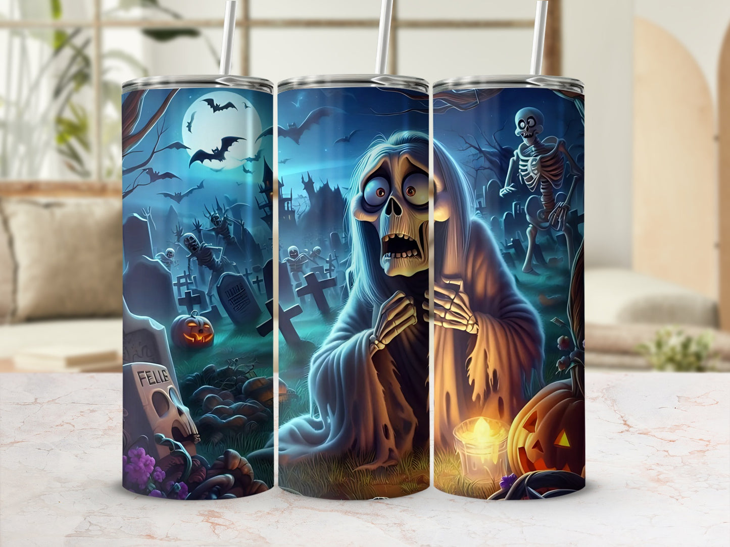 Three tumblers with spooky Halloween graveyard scenes, bats, skeletons, and pumpkins.