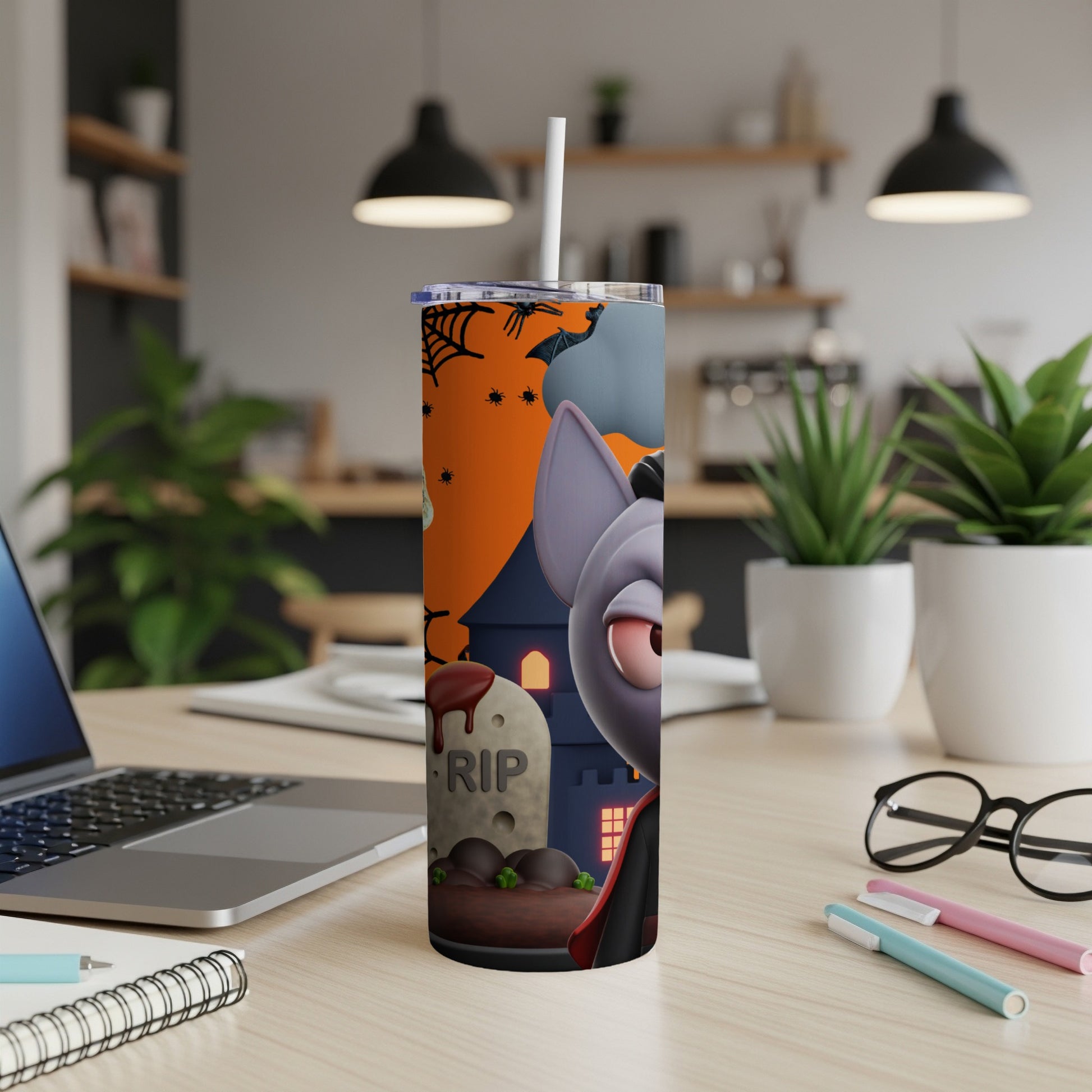 Halloween tumbler with cartoon vampire, haunted house, and RIP tombstone design.