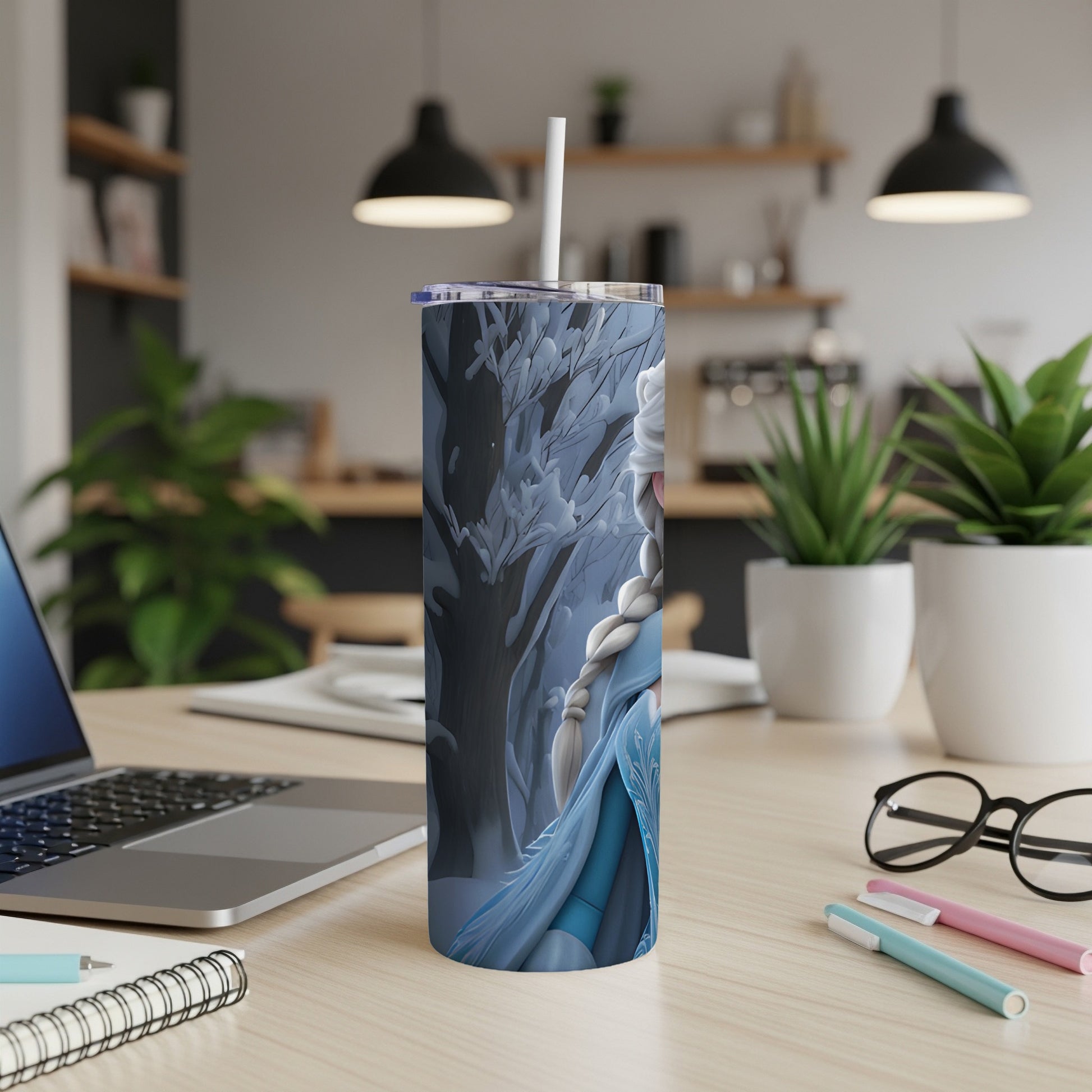 Frozen Elsa on a blue and white tumbler with a straw, on a desk.