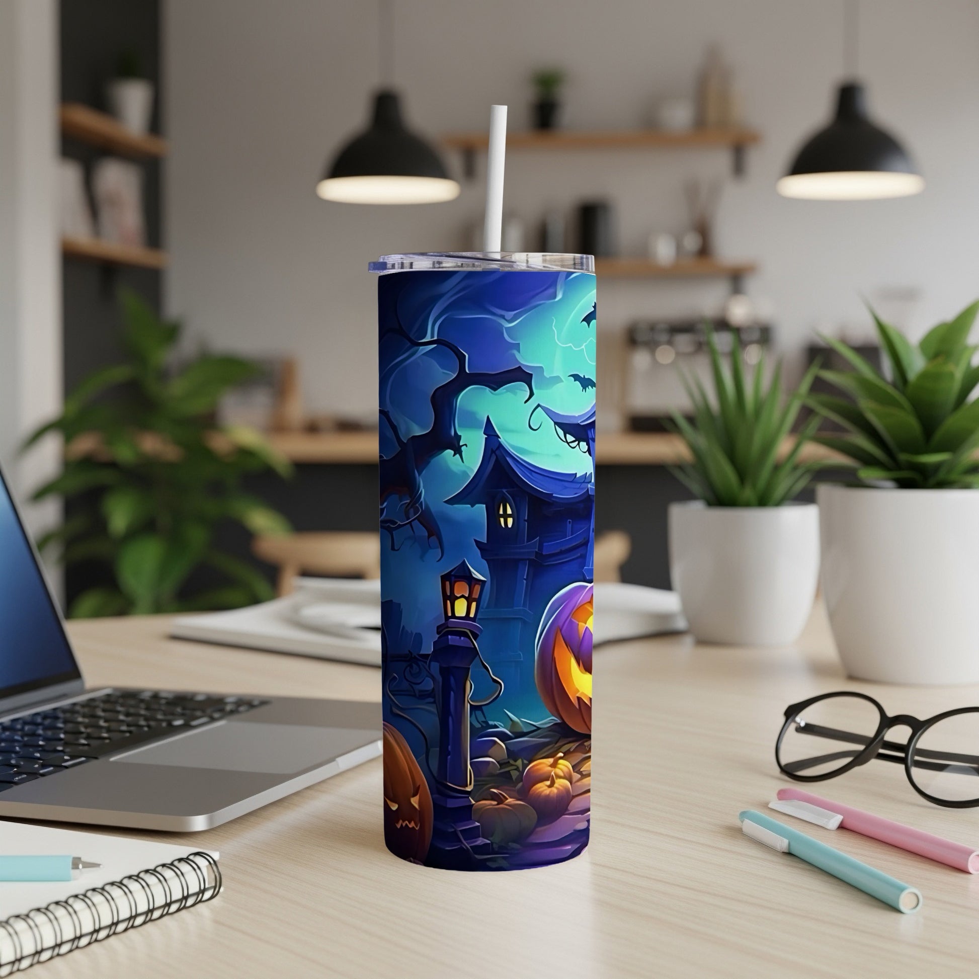 Tumbler with Halloween theme art featuring a spooky house, pumpkins, and bats.