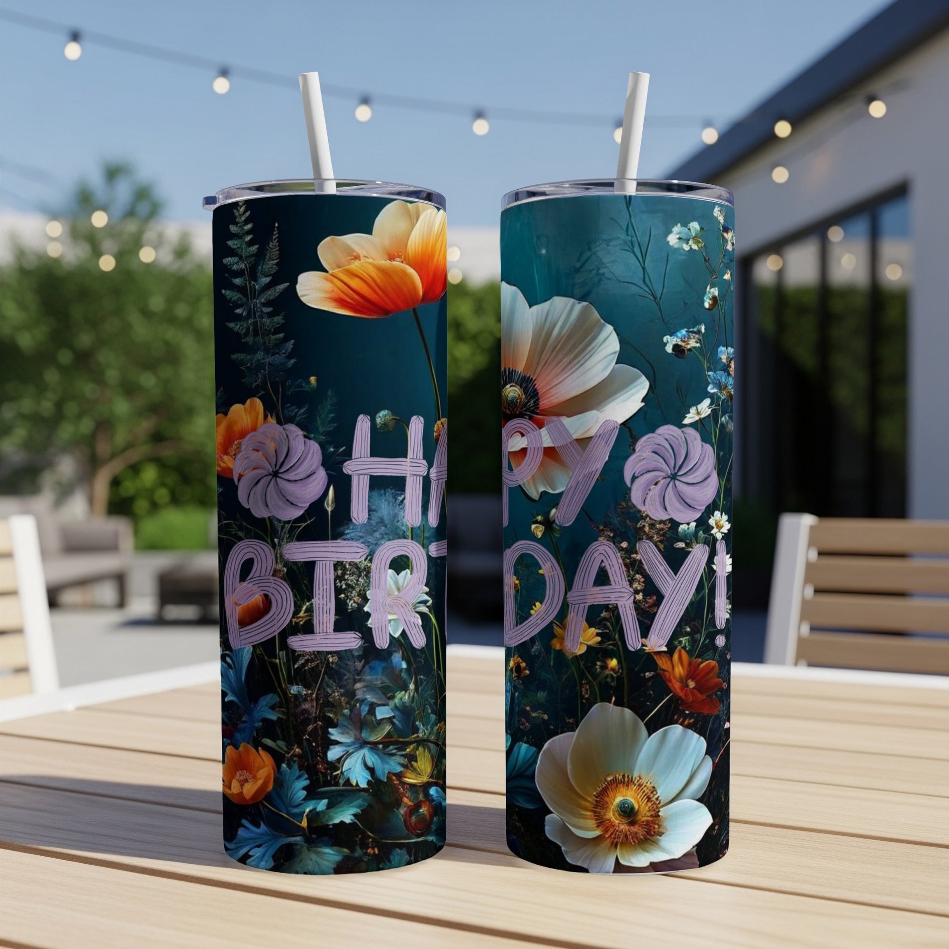 Two tumblers with "Happy Birthday!" text and a floral design on a table.