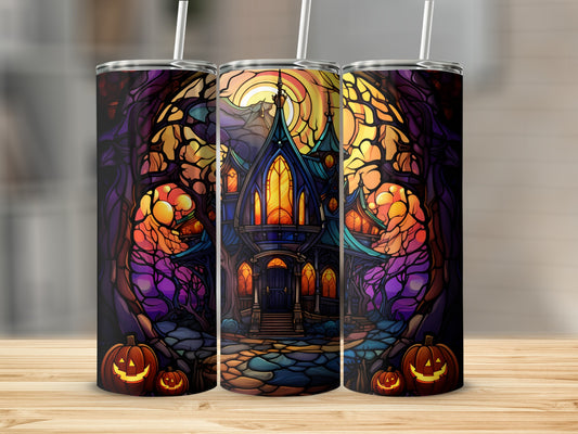 Spooky haunted house with stained glass windows and pumpkins on a tumbler.