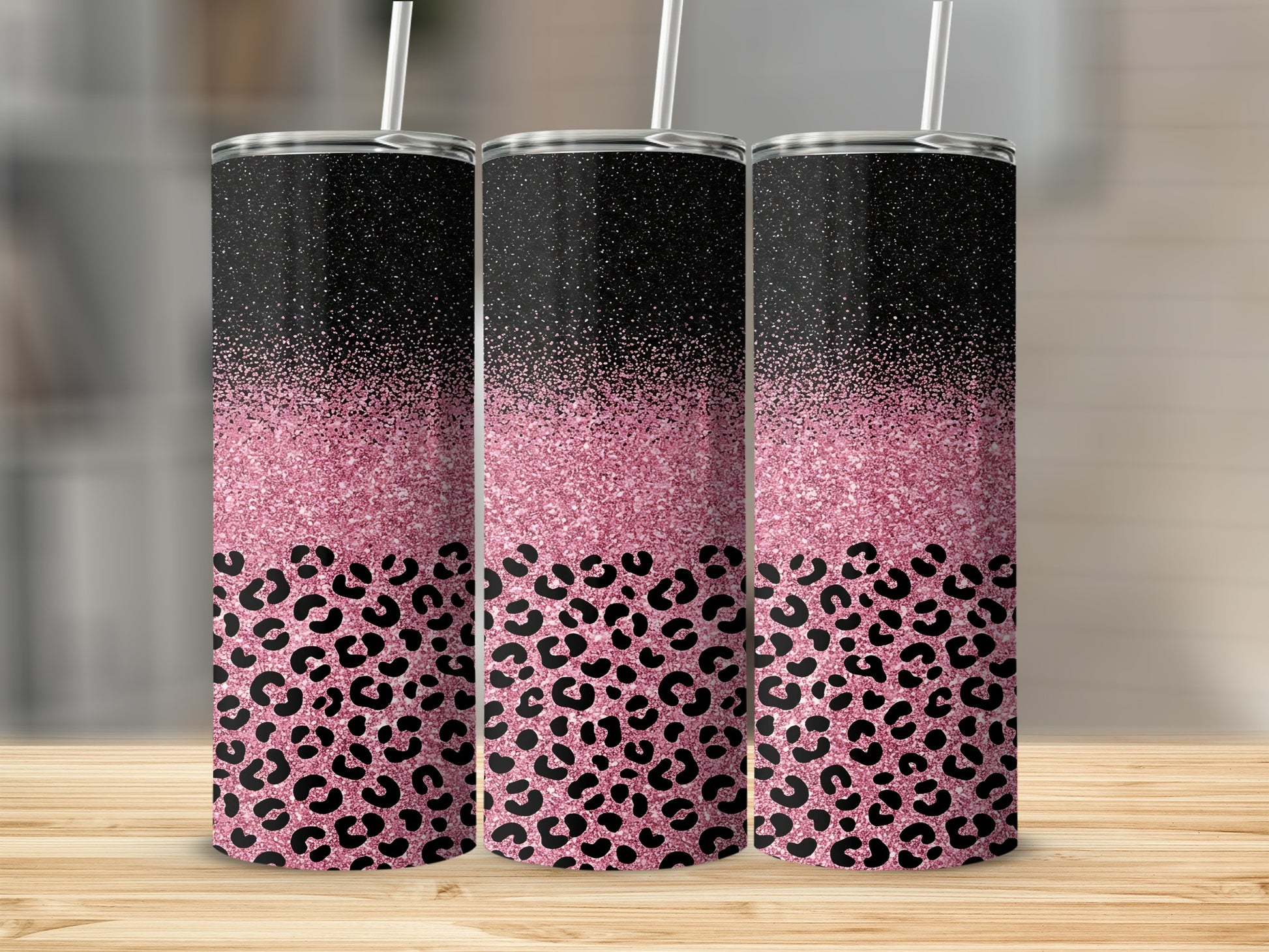 Three tumblers with black tops, pink glitter, and leopard print bottoms.
