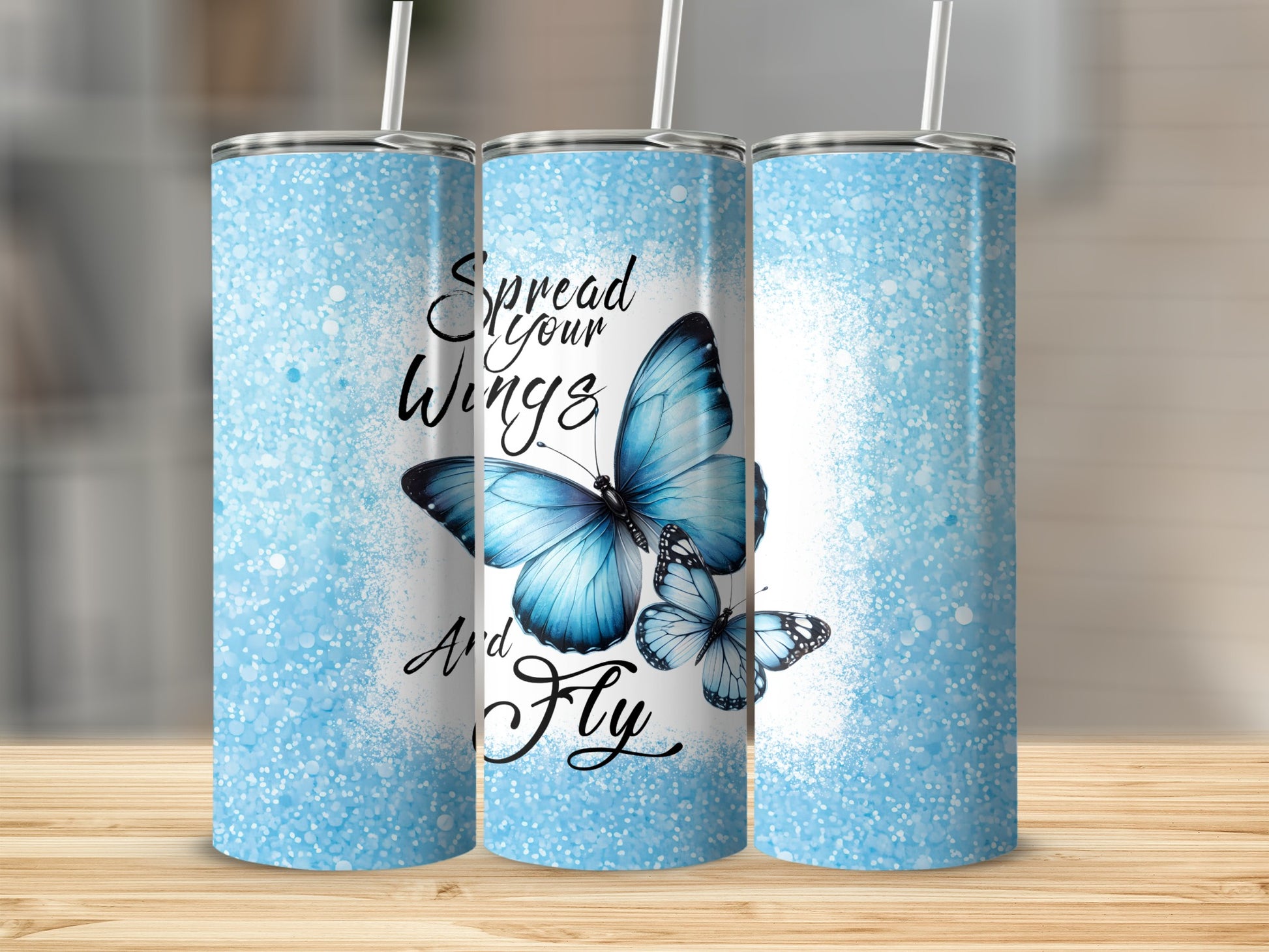 Three blue butterfly tumblers with "Spread Your Wings and Fly" text.