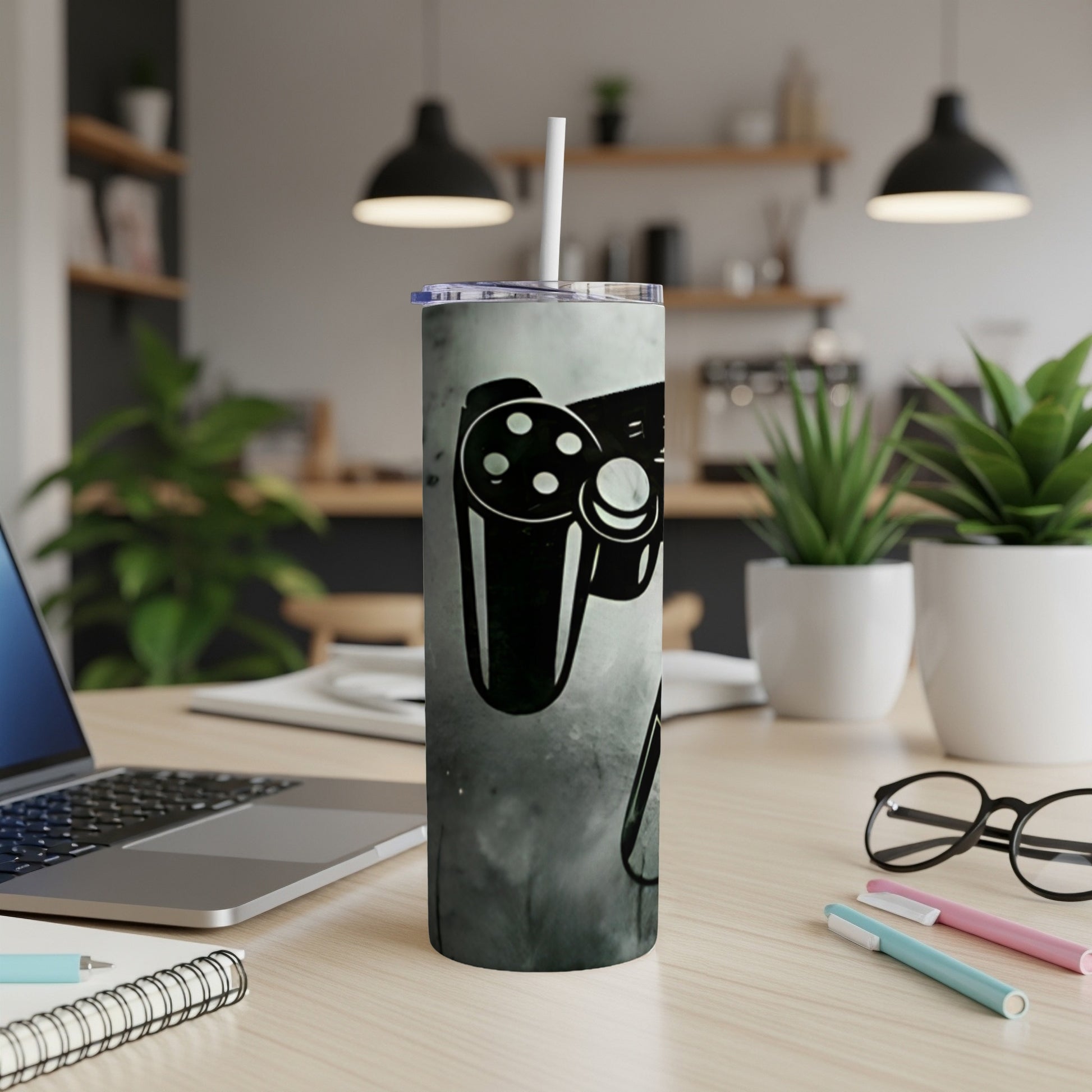 Slim tumbler with a black and white video game controller design.