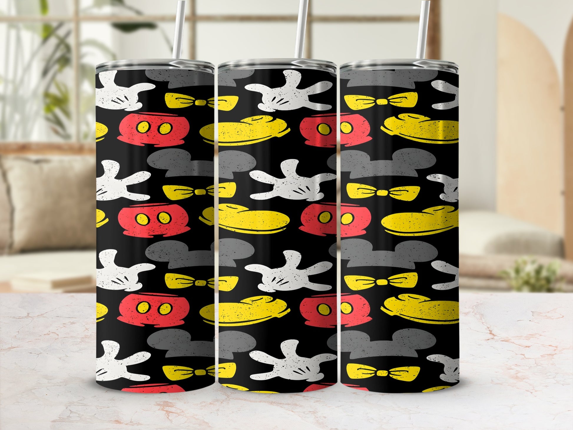 Three tumblers with a repeating Mickey Mouse glove, bow, and ear pattern.
