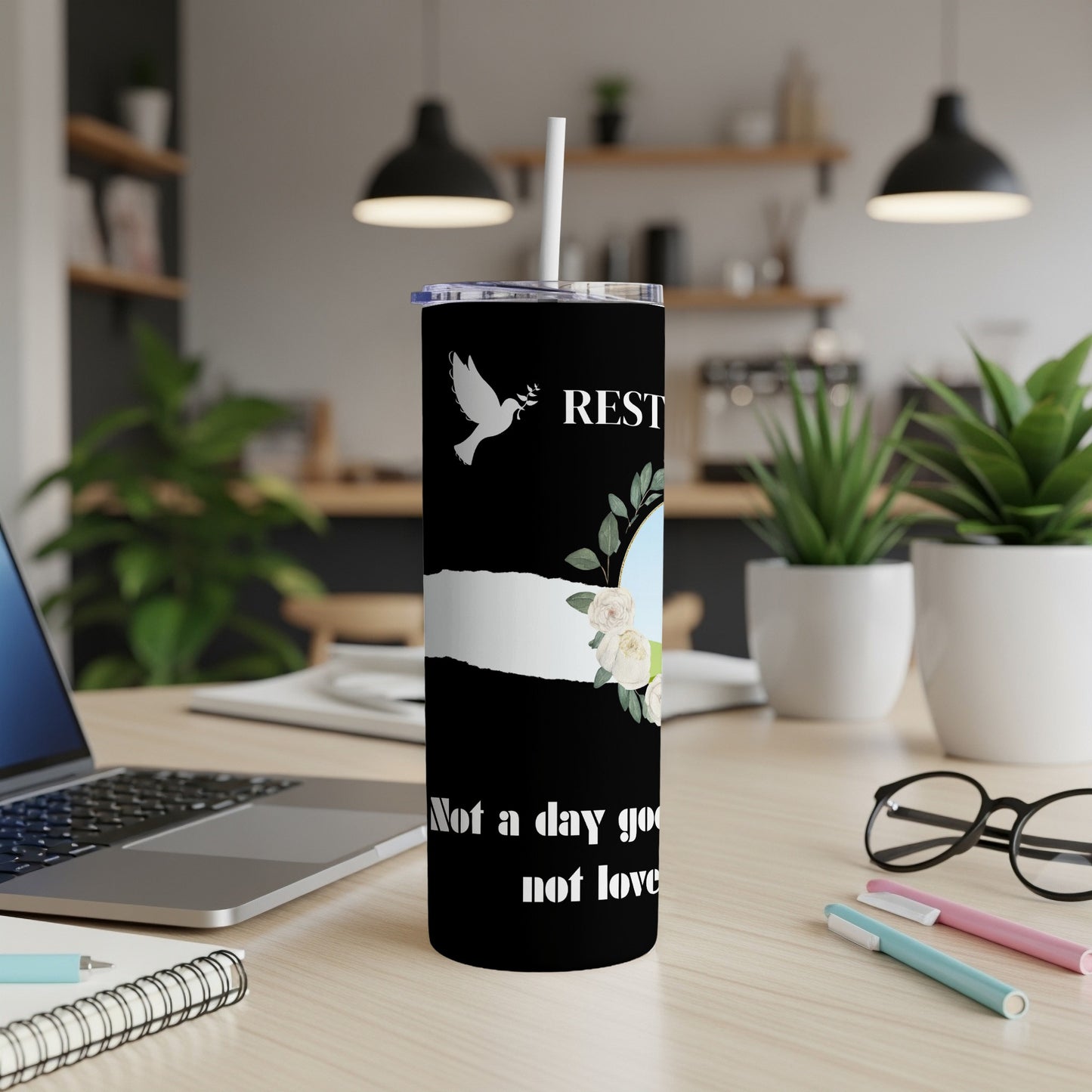 Black tumbler with dove, floral design, and text "REST not a day goo not love".
