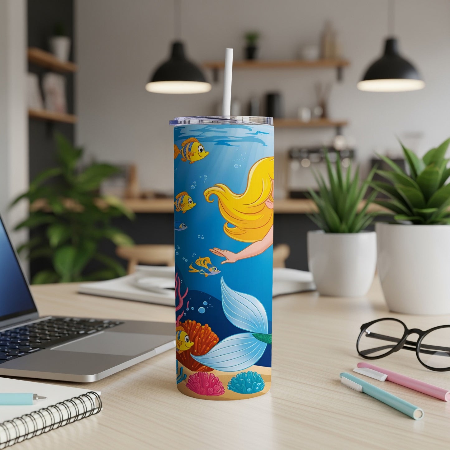 Mermaid tail and ocean life on a tumbler with a straw.
