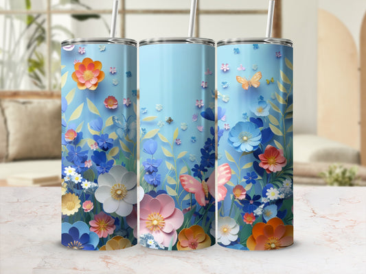 Blue tumbler with colorful floral and butterfly design.
