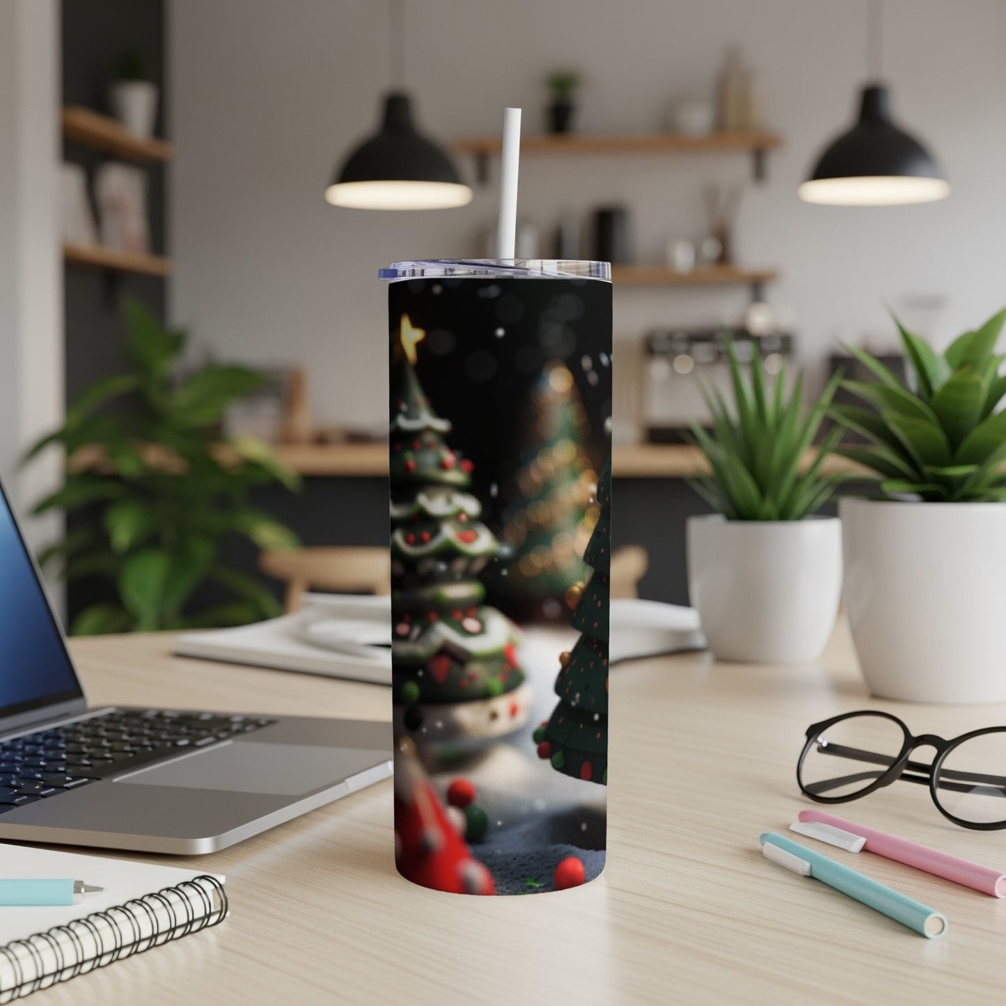 Christmas tree pattern on a white tumbler on a desk.