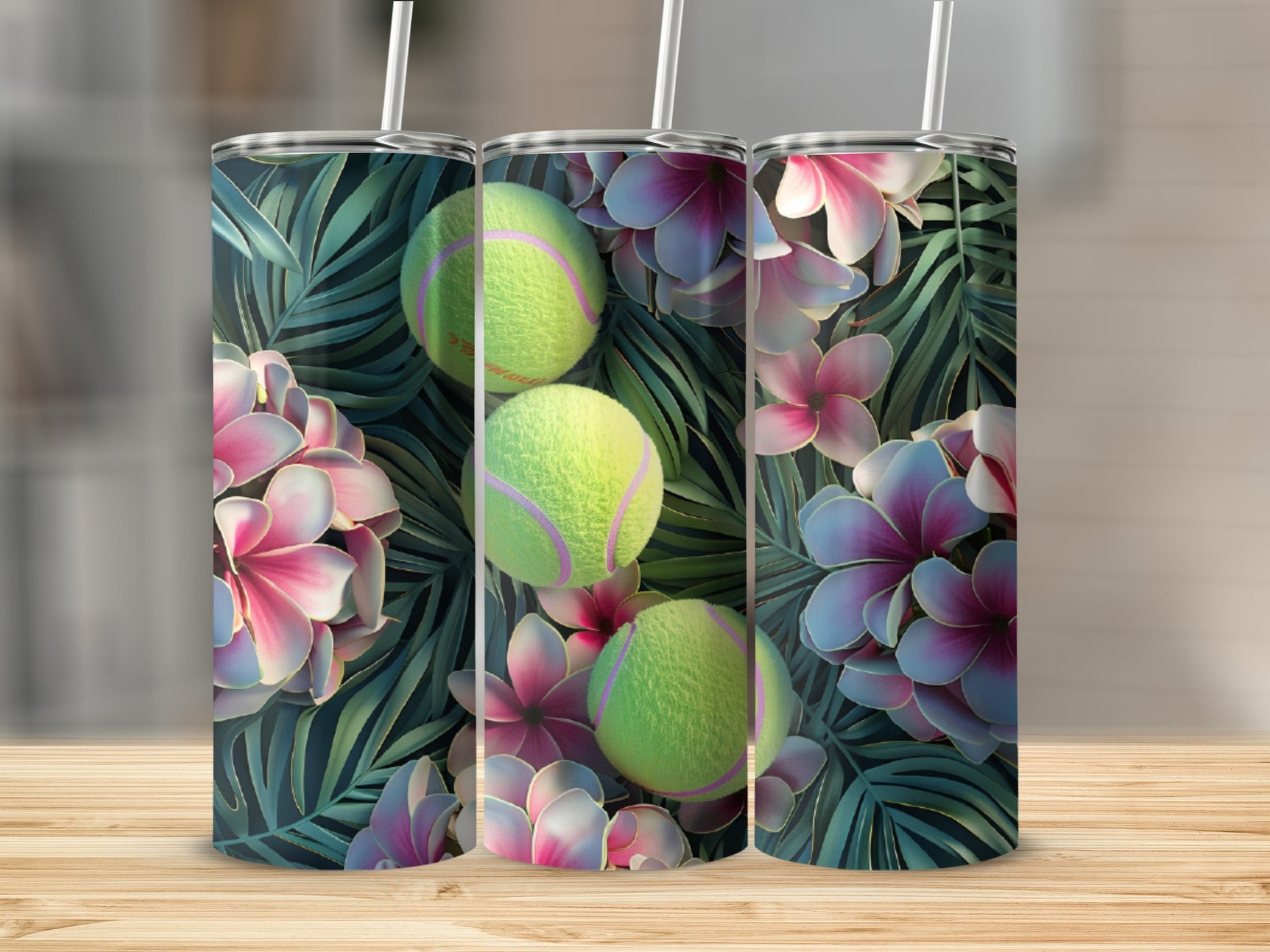 Three tennis balls with tropical flowers and leaves pattern on tumblers.