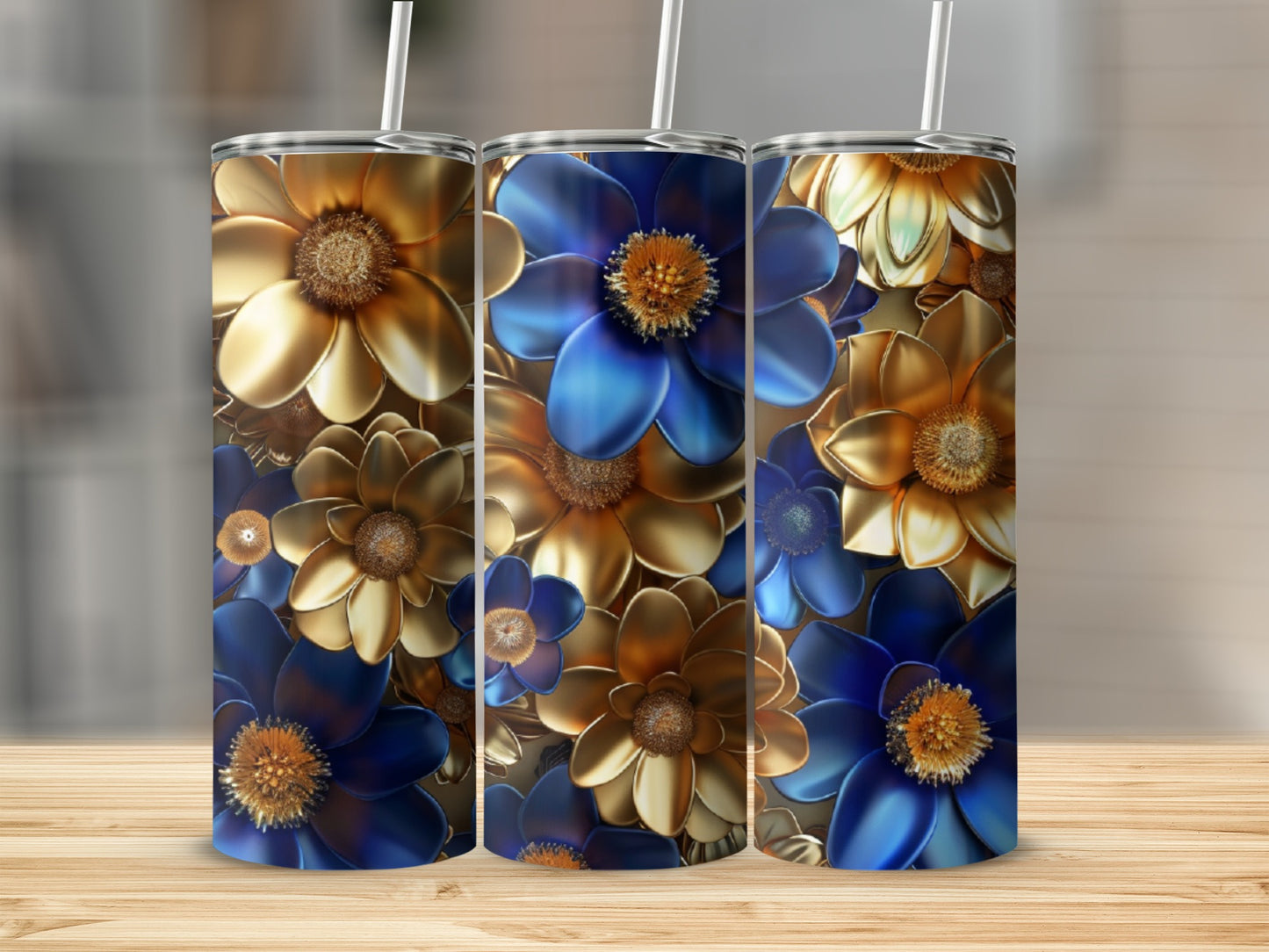 Three tall tumblers with gold and blue floral designs.