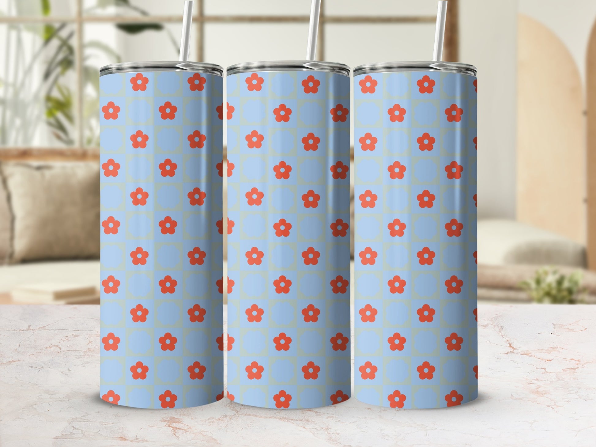 Three light blue tumblers with a red floral pattern and straws.