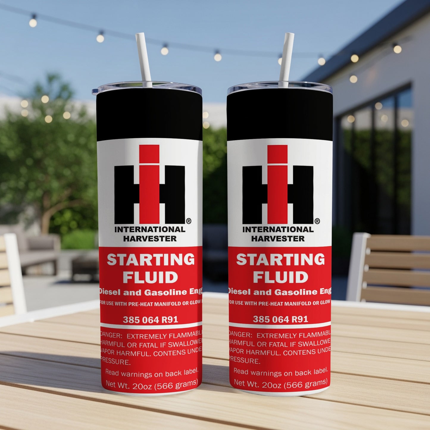 Two International Harvester starting fluid cans with straws, one slightly in front of the other.