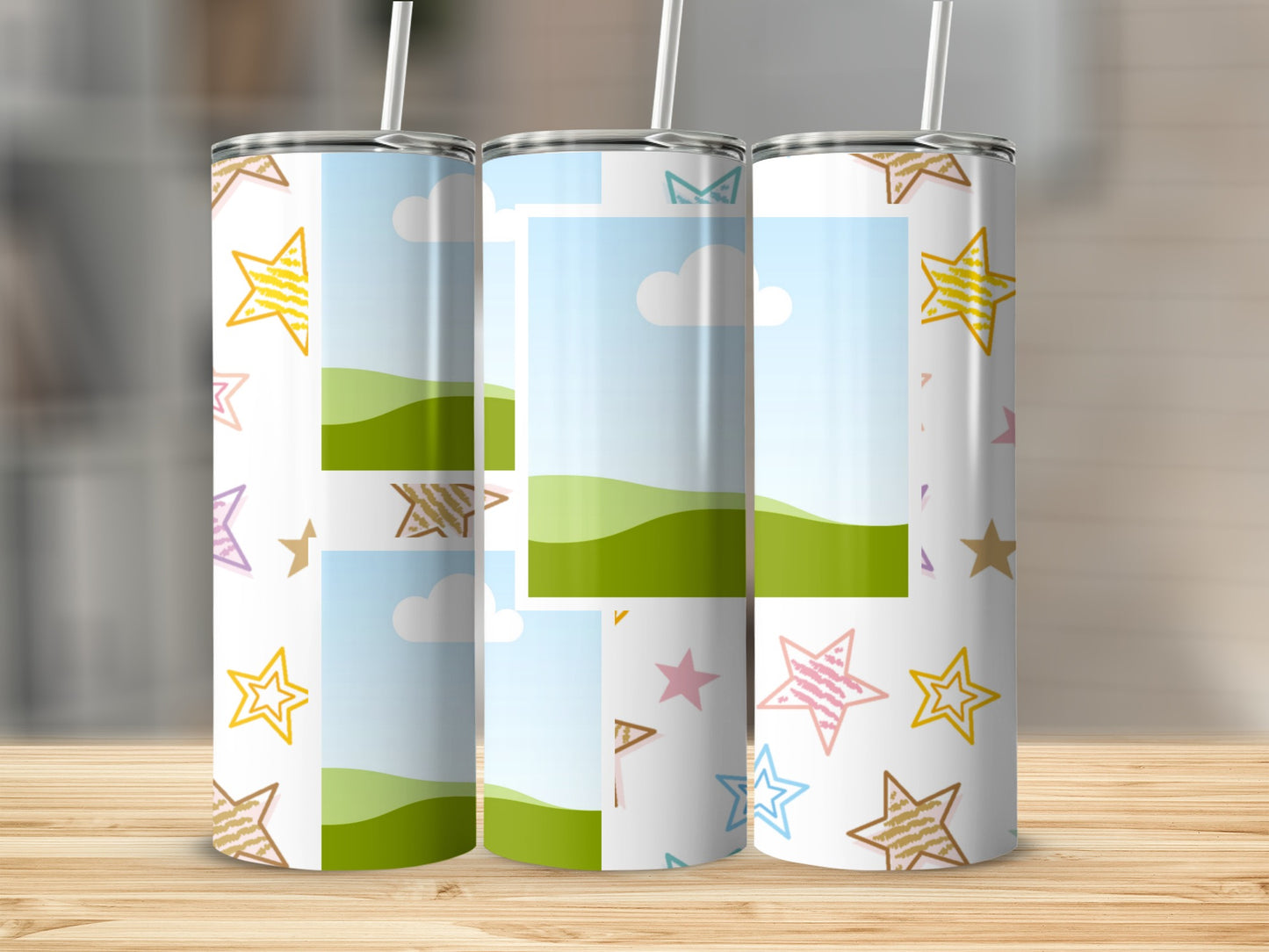 Three tumblers with cartoon stars and landscape inserts sit on a wooden surface.