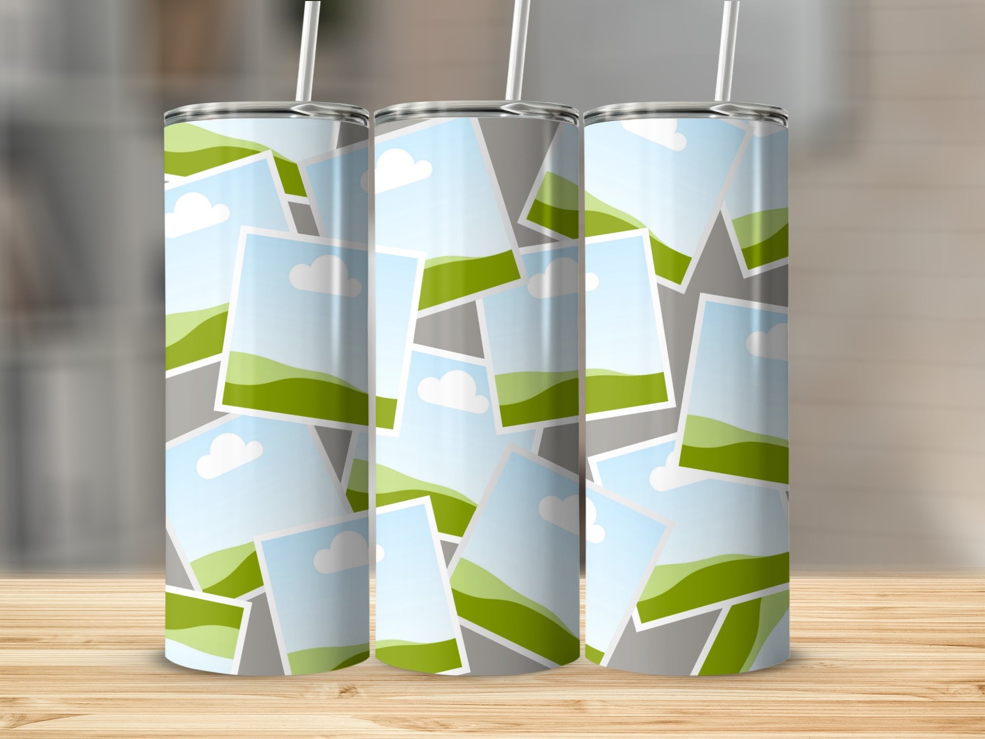 Three tumblers with a collage of landscape photos featuring green hills and clouds.