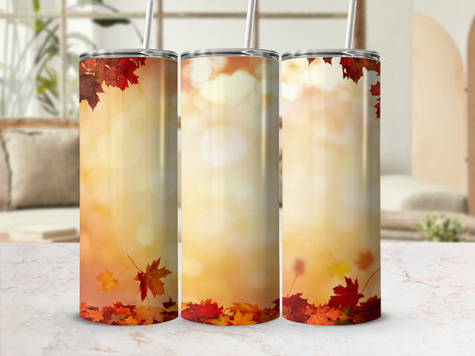 Three tumblers with fall leaves and bokeh background.