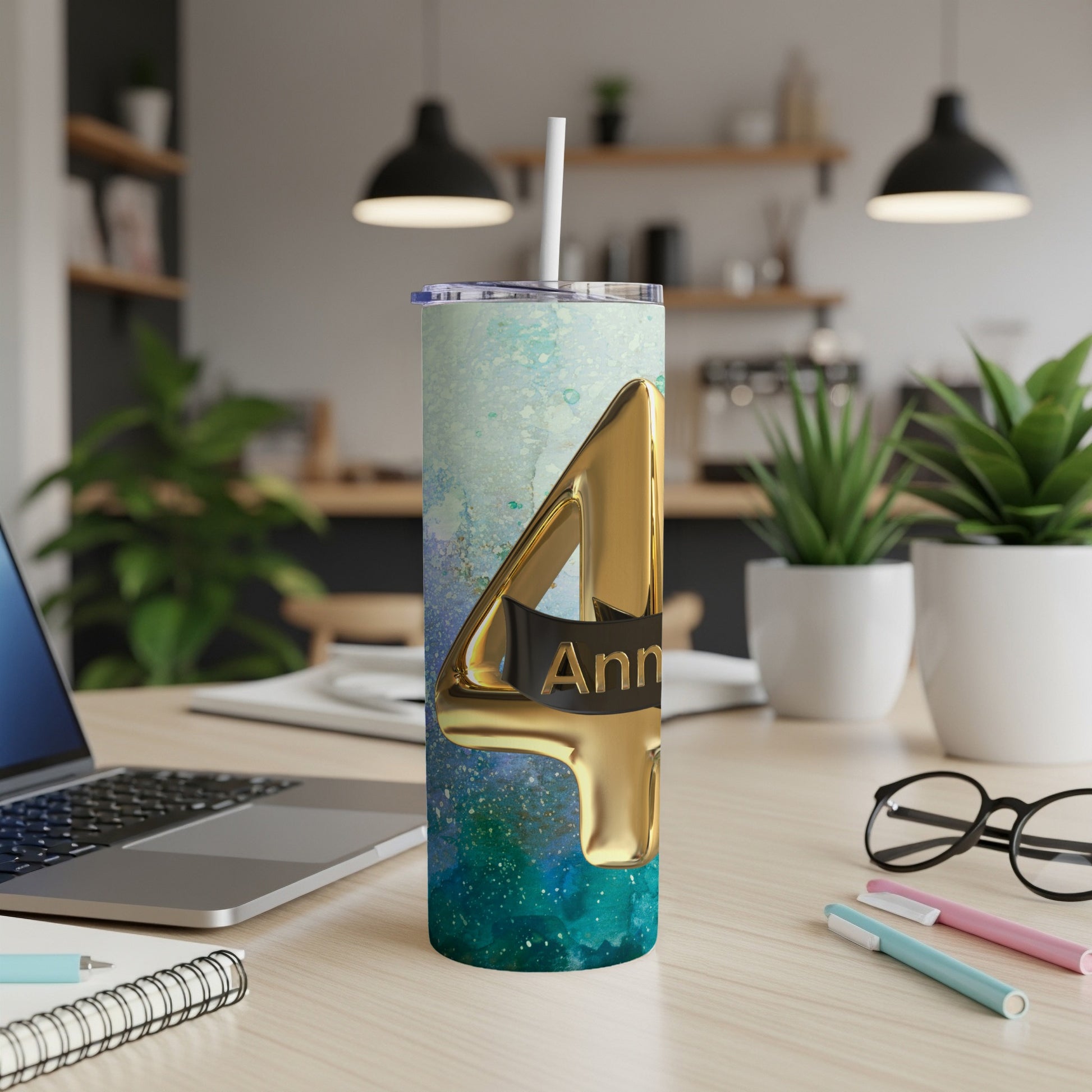 Gold "4" on a speckled blue and green tumbler with a straw.