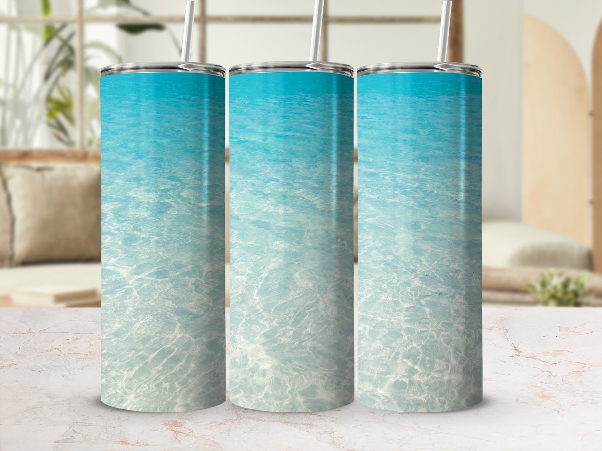 Three tumblers with a turquoise water and light reflection design.