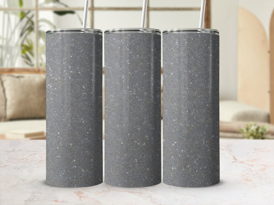 Three glittery gray tumblers with straws sit in a row.