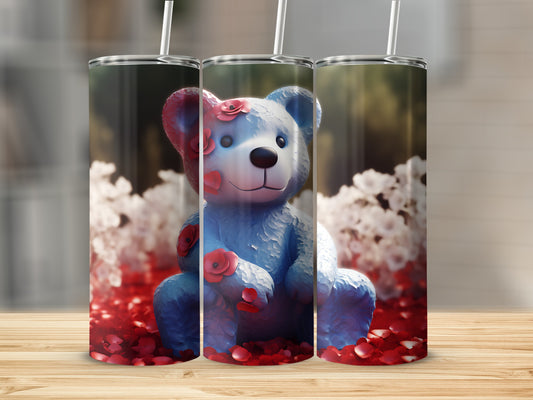 Blue teddy bear with roses, surrounded by red rose petals and white flowers.