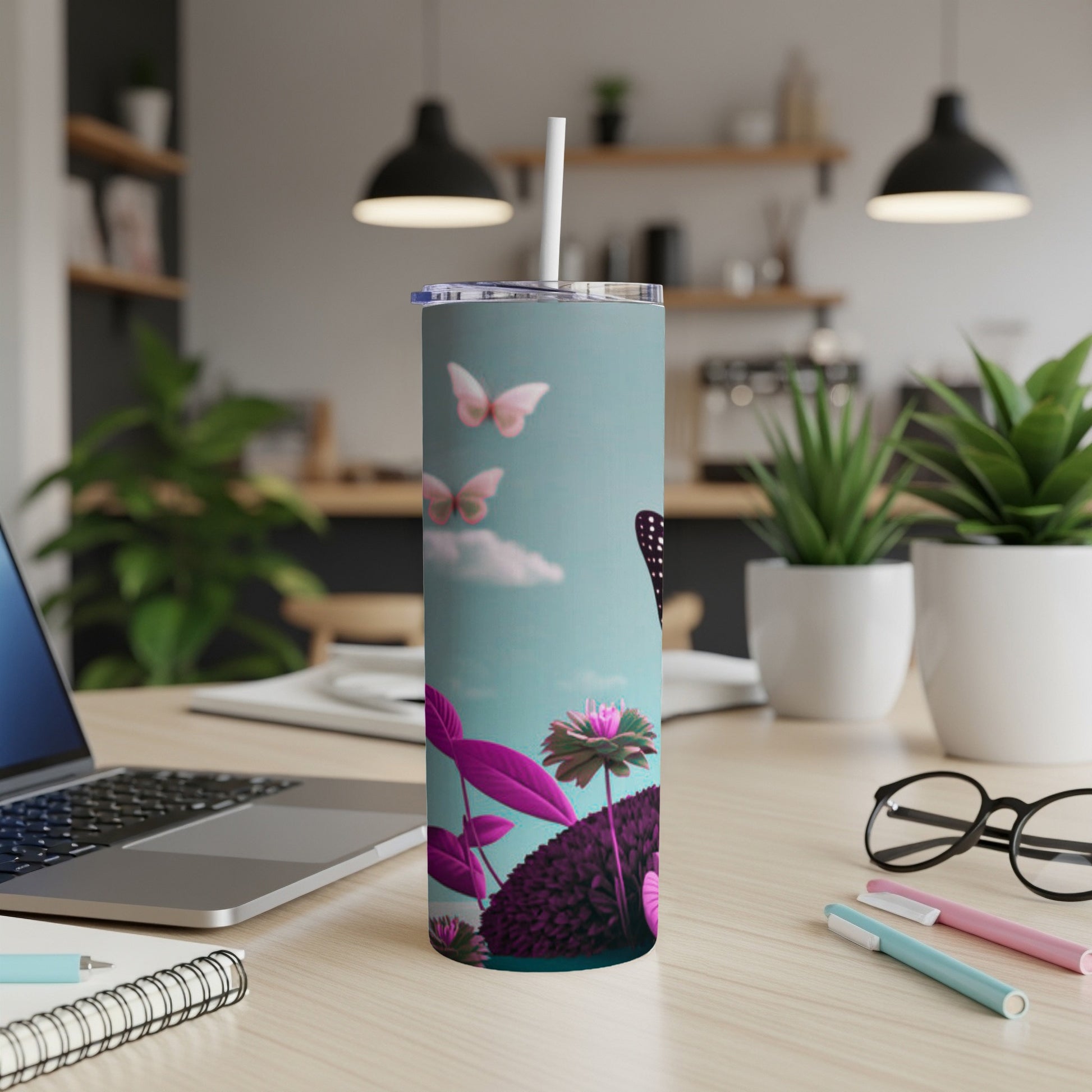 Slim tumbler with butterflies and pink foliage against a blue sky.