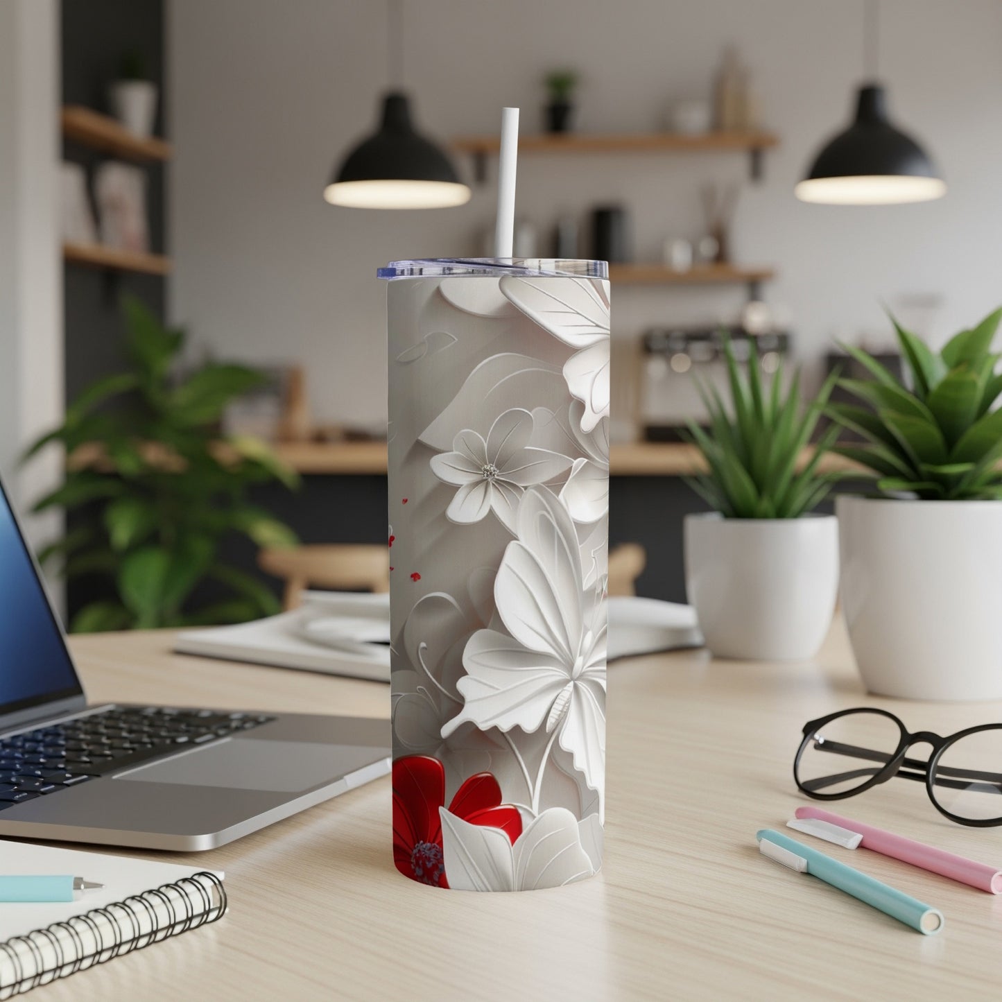 White tumbler with floral and butterfly pattern, red accents.
