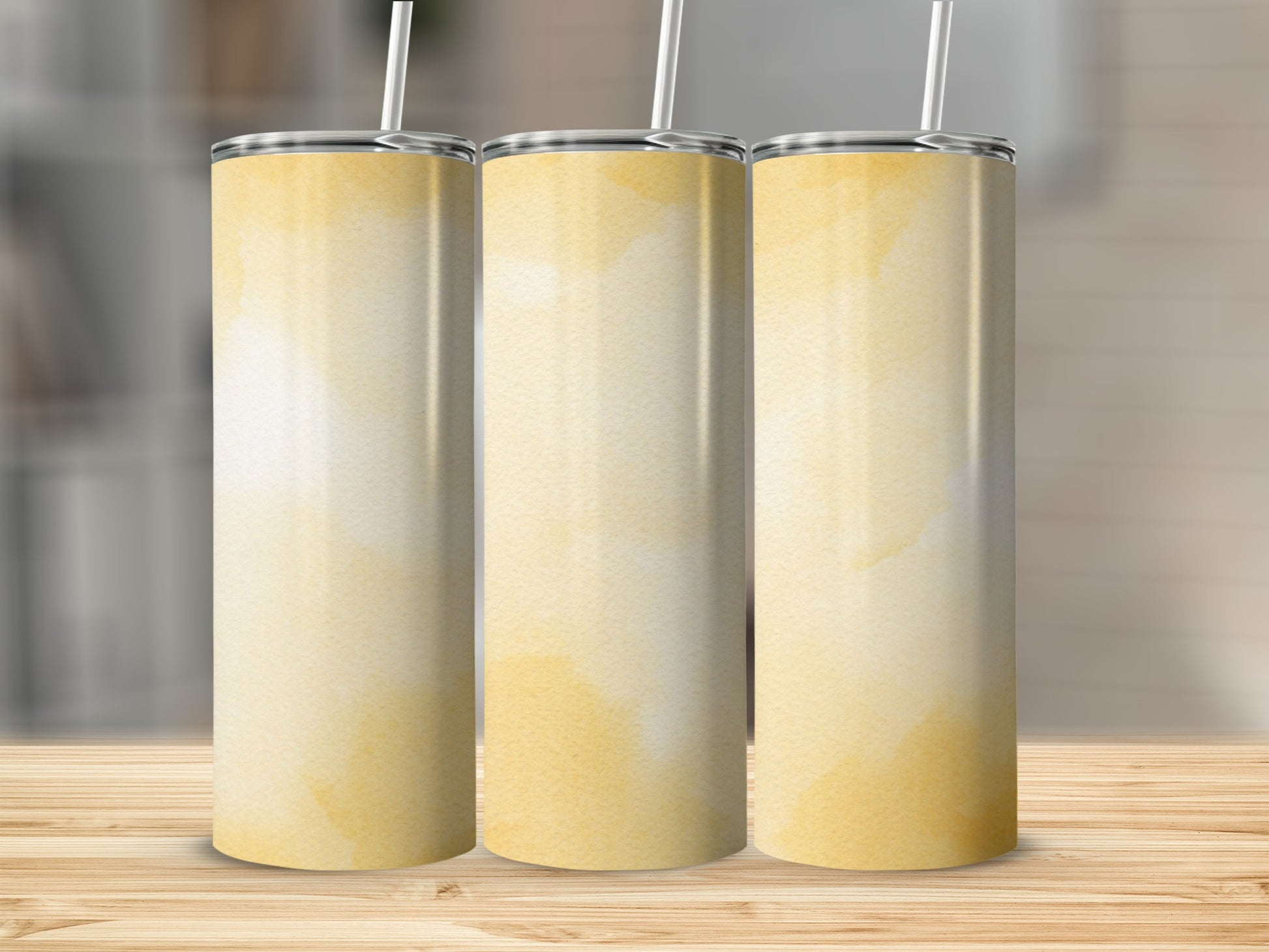 Three tall, tapered tumblers with a watercolor yellow abstract pattern.