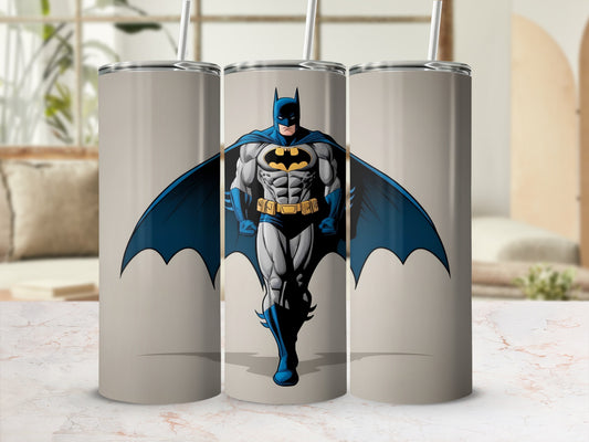 Batman in cowl and cape, standing heroically on a light gray tumbler.