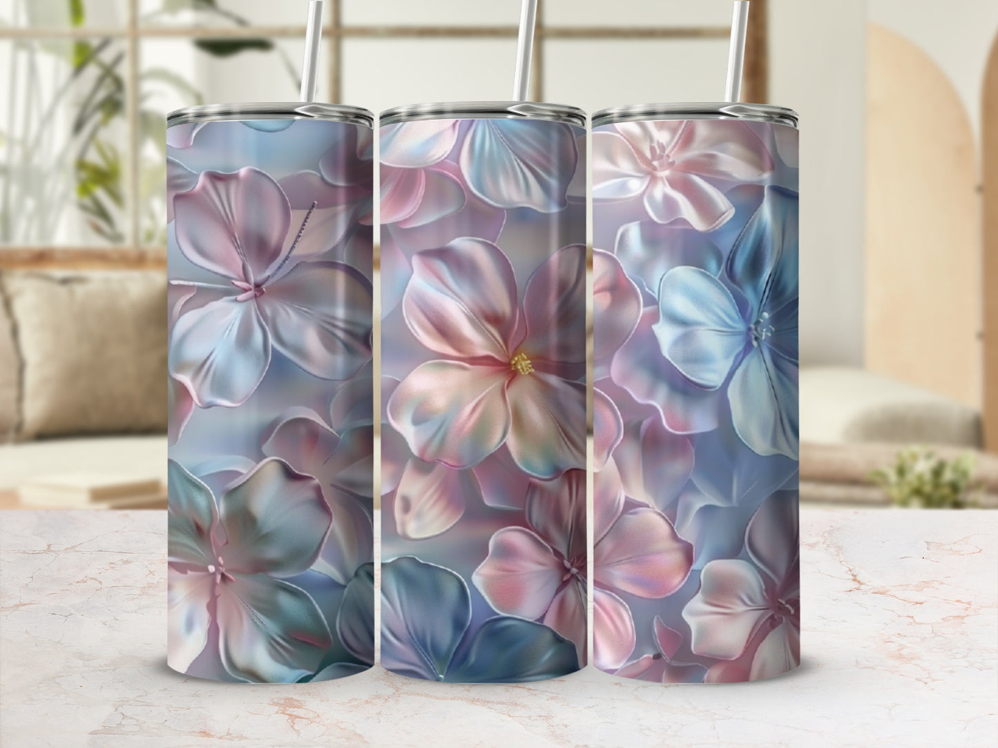 Three tumblers with a pastel floral design on a marble countertop.