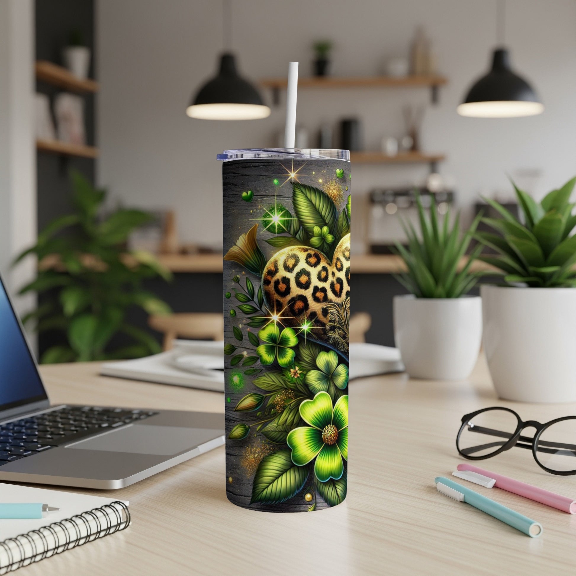 Green shamrocks and leopard print adorn a skinny tumbler with a straw.