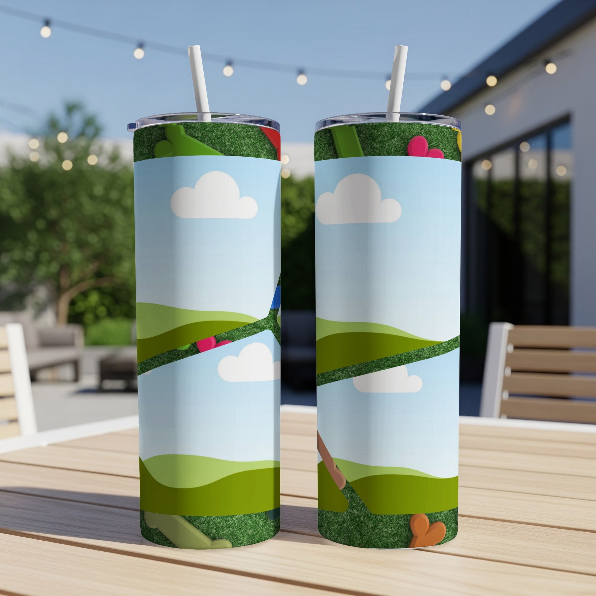 Two tumblers with a cartoon landscape design, featuring hills and clouds.