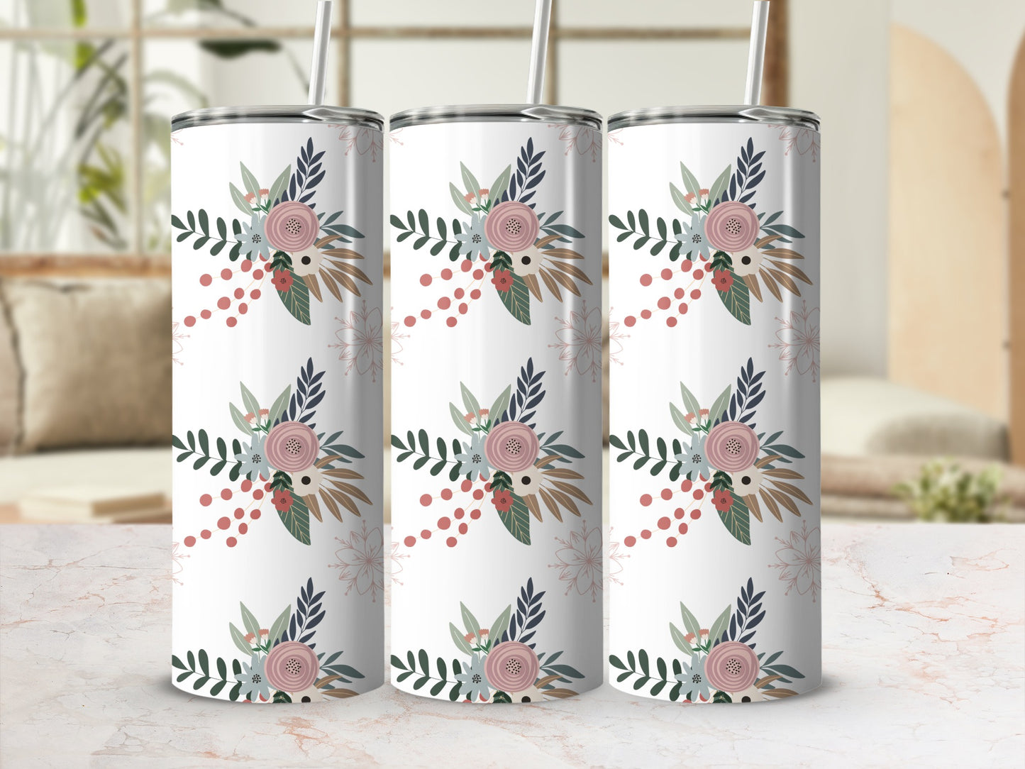 Three white tumblers with a floral and leaf pattern on a marbled countertop.