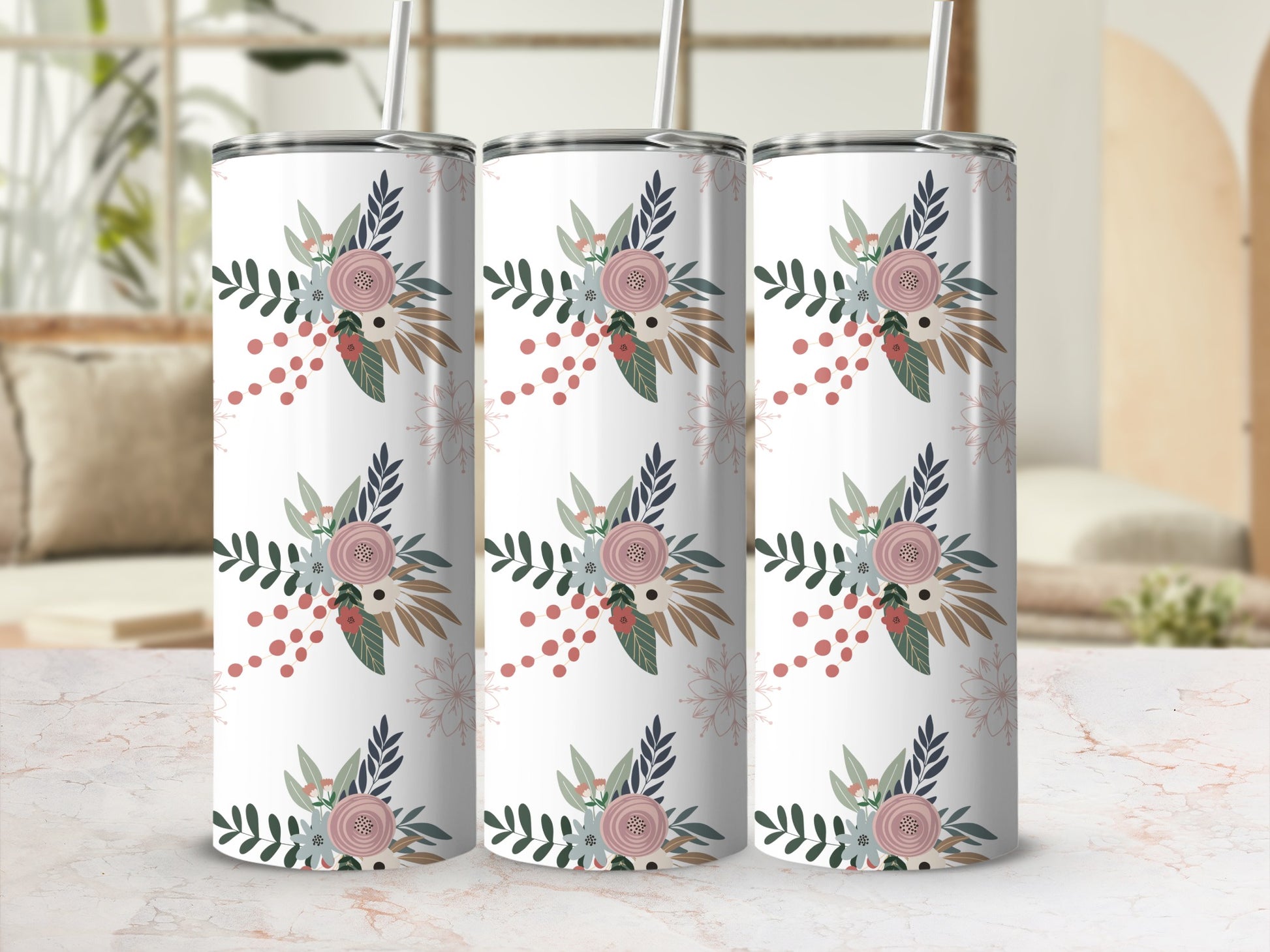 Three white tumblers with a floral and leaf pattern on a marbled countertop.