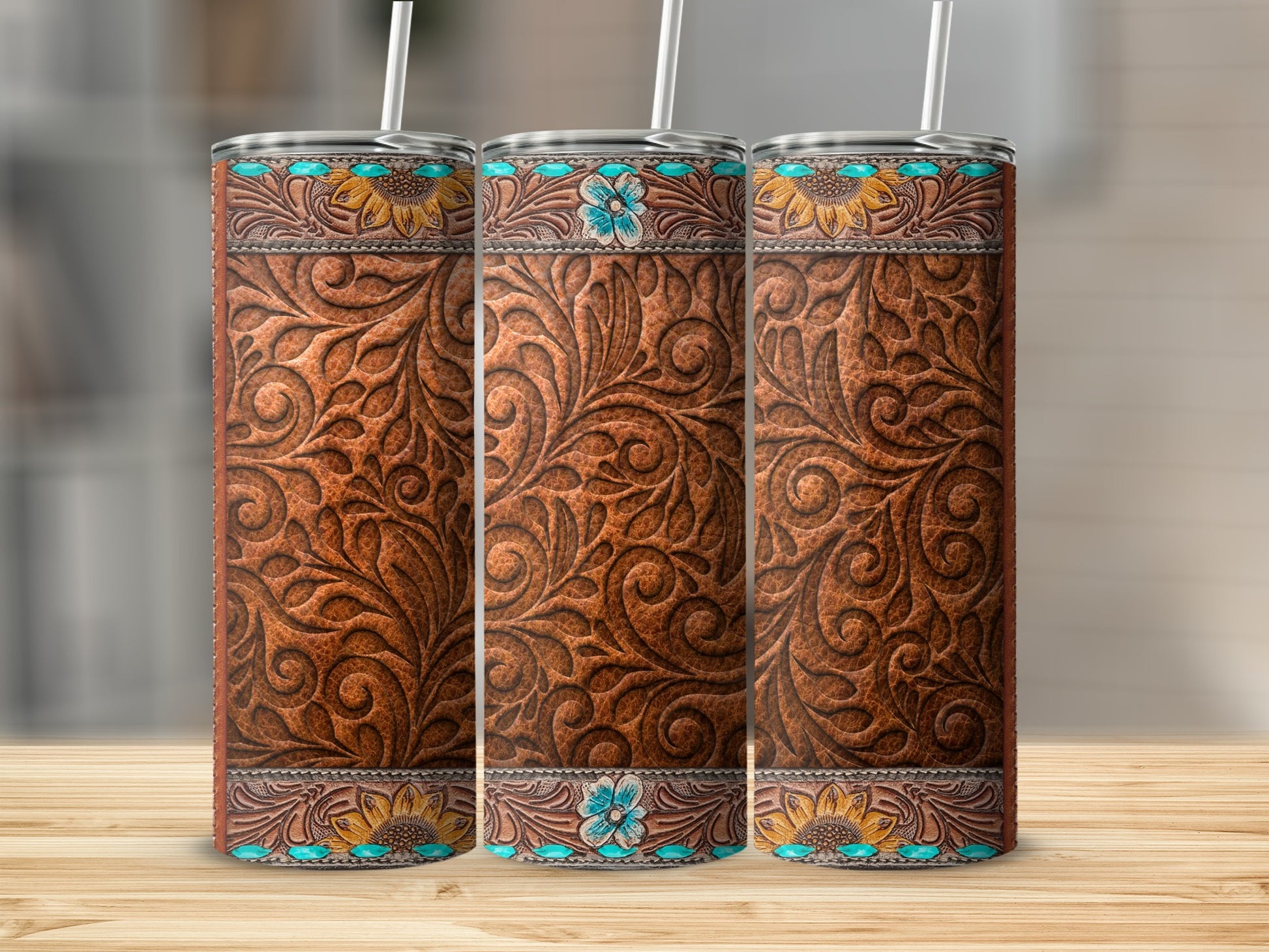 Three western-style tumblers with embossed leather and floral designs.