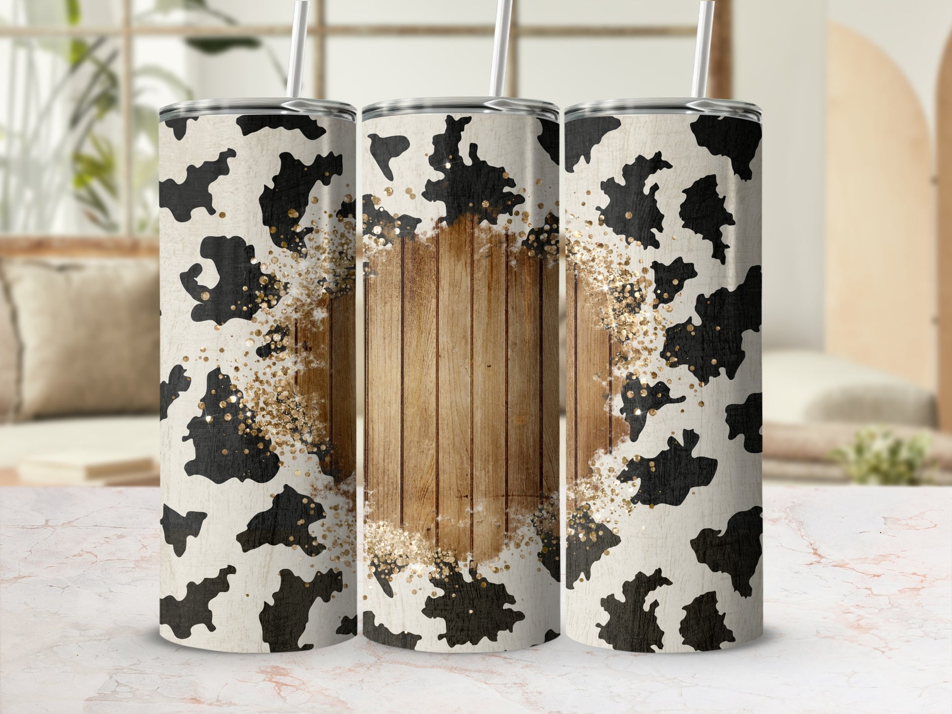 Cow print tumbler with wood grain center and gold glitter accents.