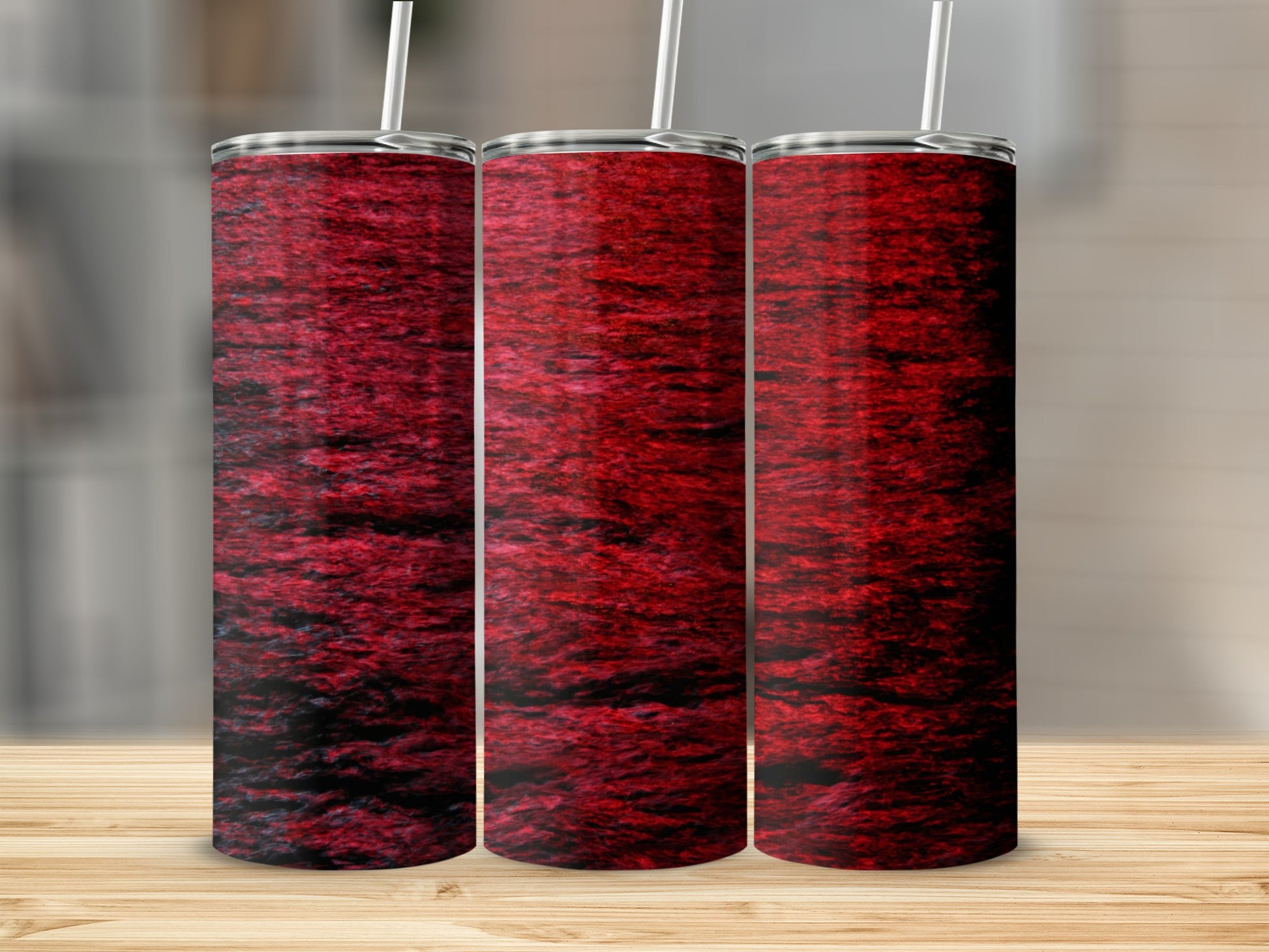 Three stainless steel tumblers with a dark red, textured pattern.